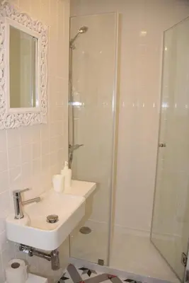 a bathroom with a sink and a shower at Porto Traveler Apartment in Porto