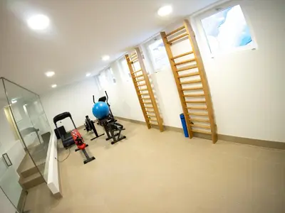 a gym with exercise equipment in a room with a window at Unique Penthouse Porto near Livaria Lello - 40m2 Terrace and Free Parking in Porto