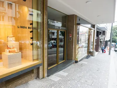 a store window of a store on a city street at Unique Penthouse Porto near Livaria Lello - 40m2 Terrace and Free Parking in Porto