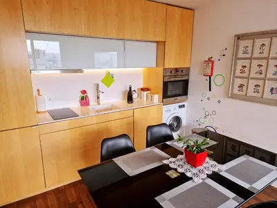 a dining room with a table and a kitchen at Unique Penthouse Porto near Livaria Lello - 40m2 Terrace and Free Parking in Porto