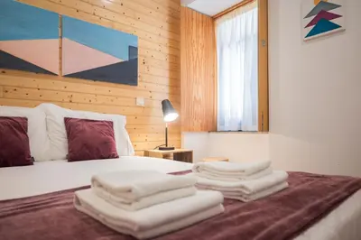 a bedroom with a bed with towels on it at Central Luxury apartment w AC Downtown and Metro in Porto