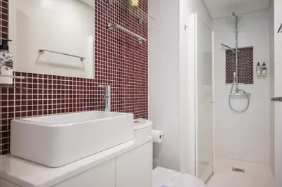 a white bathroom with a sink and a toilet at Central Luxury apartment w AC Downtown and Metro in Porto