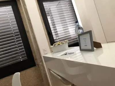 a bottle of wine sitting on a counter next to a window at URBAN VIEWS Terrace - Duplex Apartment 