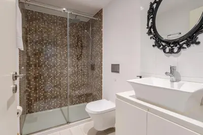 a bathroom with a sink and a toilet and a mirror at Renovated & Quiet 1-Bedroom in Santa Catarina in Porto