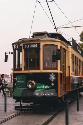 a trolley car is on the tracks at Renovated & Quiet 1-Bedroom in Santa Catarina in Porto