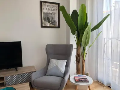a living room with a chair and a tv at URBAN VIEWS Terrace - Duplex Apartment 
