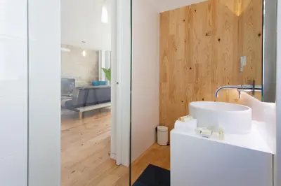 a bathroom with a white sink and a living room at URBAN VIEWS Terrace - Duplex Apartment 