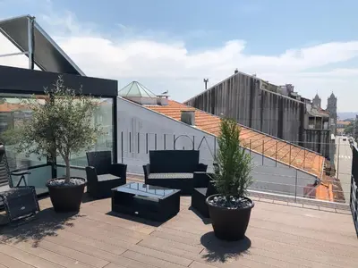 a patio with furniture and plants on a roof at URBAN VIEWS Terrace - Duplex Apartment 