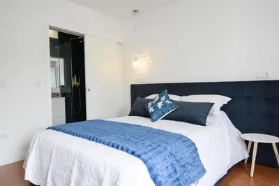 a bedroom with a bed with a blue and white blanket at LUXURY Golden River Apartment - In the Heart of city center and wine cellars in Vila Nova de Gaia
