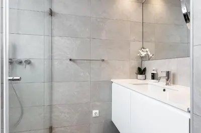 a bathroom with a shower and a sink at Central Porto 1BR Apartment - Oporto Bridges in Porto