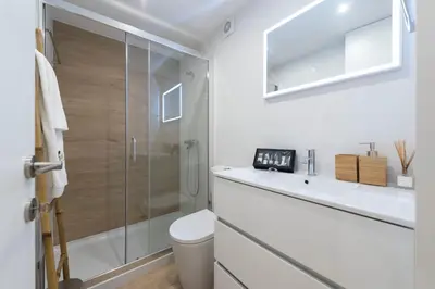 a bathroom with a shower and a toilet and a sink at BmyGuest Collection - Downtown Mezzanine Apartment in Porto