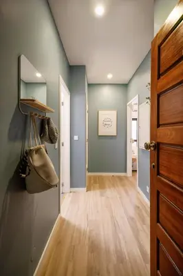 a hallway with blue walls and a wooden floor at Porto Haven - Downtown by the Metro in Porto