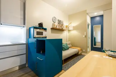 a blue cabinet in a living room with a microwave at Porto Haven - Downtown by the Metro in Porto