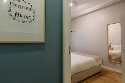 a bedroom with a bed and a mirror at Porto Haven - Downtown by the Metro in Porto