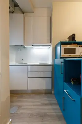 a kitchen with blue and white cabinets and a microwave at Porto Haven - Downtown by the Metro in Porto