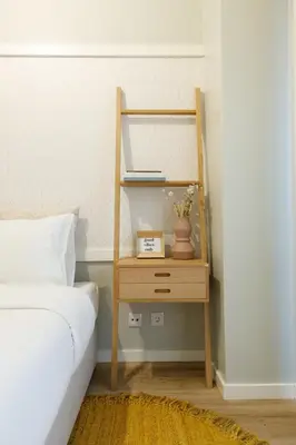 a bedroom with a bed and a wooden bedside table with a night stand at Porto Haven - Downtown by the Metro in Porto