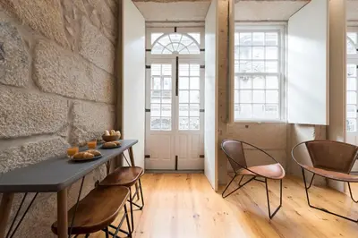 a dining room with a table and chairs at LovelyStay - Rico's Apartment - Almada 2º F in Porto