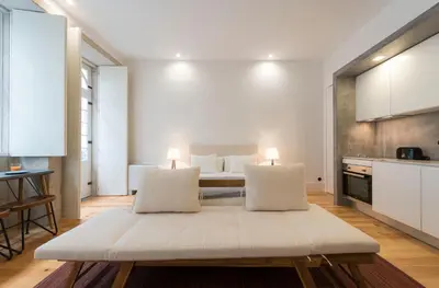 a large white room with a bed and a kitchen at LovelyStay - Rico's Apartment - Almada 2º F in Porto