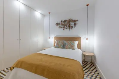 a bedroom with a bed with white walls at Porto Blue Terrace in Porto