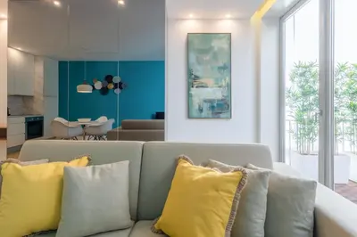 a living room with a couch with yellow pillows at Porto Blue Terrace in Porto