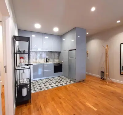 a large kitchen with stainless steel appliances and wood floors at Porto Soul by Flat in Porto in Porto
