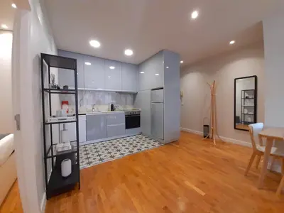 a kitchen with blue cabinets and a wooden floor at Porto Soul by Flat in Porto in Porto