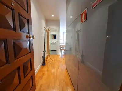 a hallway with a door and a room with a table at Porto Soul by Flat in Porto in Porto