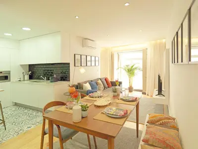 a kitchen and living room with a table and a couch at FLH Porto Modern Apartment in Porto