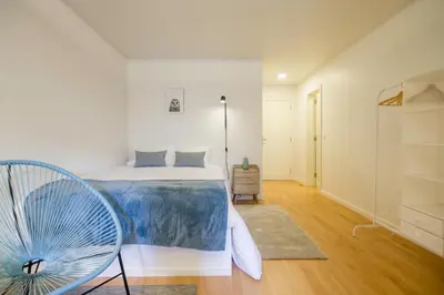 a bedroom with a bed and a fan at Republica Apartments at D. Luis I Bridge in Vila Nova de Gaia