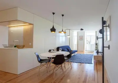 a kitchen and dining room with a table and chairs at Liiiving in Porto | Central Secret Balcony in Porto