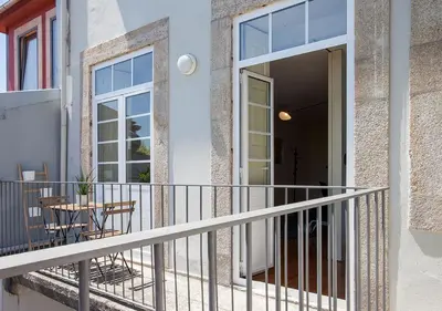a balcony of a house with a table and chairs at Liiiving in Porto | Central Secret Balcony in Porto