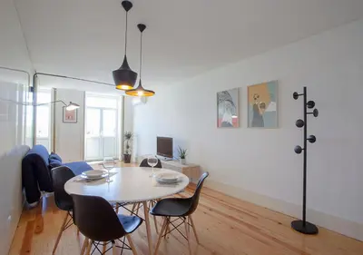 a dining room with a table and chairs at Liiiving in Porto | Central Secret Balcony in Porto