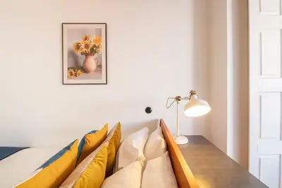 a room with a couch and a table with yellow pillows at LovelyStay - Dirk Apartment Almada 3º T in Porto