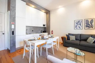 a living room with a white table and a couch at LovelyStay - Dirk Apartment Almada 3º T in Porto