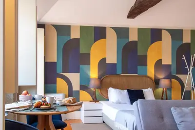 a bedroom with a bed and a colorful wall at LovelyStay - Dirk Apartment - Almada 4º F in Porto