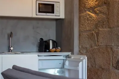 a kitchen with a counter top with a microwave at LovelyStay - Dirk Apartment - Almada 4º F in Porto
