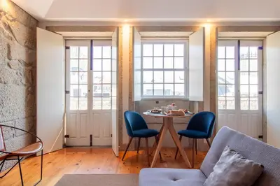 a living room with a table and chairs at LovelyStay - Dirk Apartment - Almada 4º F in Porto