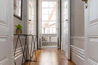 a hallway with a large window and a wooden floor at AD Apartment - Solar da Avenida in Porto