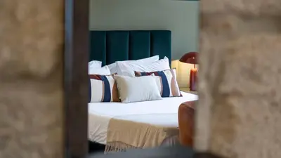 a bedroom with a bed with white sheets and pillows at LovelyStay - Allderman Apartment - Almada 3º F in Porto