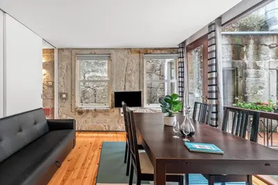 a dining room with a table and a couch at OX Apartments B Places in Porto