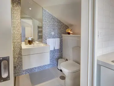 a bathroom with a toilet and a sink and a mirror at ApartmentsPorto - Bombarda 451 in Porto