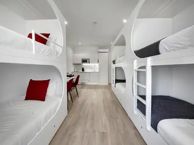 a room with two bunk beds and a desk at ApartmentsPorto - Bombarda 451 in Porto