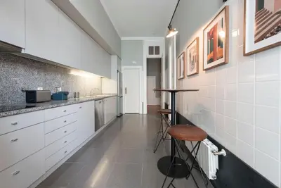 two beds in a bedroom with a blue headboard at LovelyStay - Flower Stylish Apartment in Porto