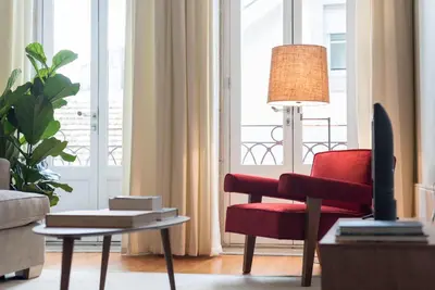 a large kitchen with white cabinets and a table at LovelyStay - Flower Stylish Apartment in Porto