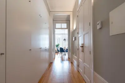 a dining room and living room with a table and chairs at LovelyStay - Flower Stylish Apartment in Porto