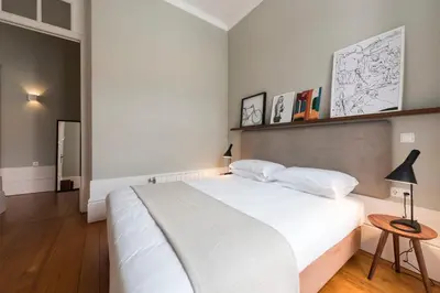 a bathroom with a tub and a toilet and a sink at LovelyStay - Flower Stylish Apartment in Porto