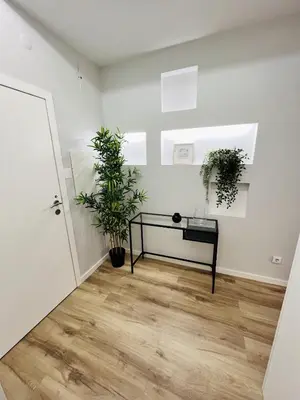 a white room with a table and plants in it at Casa de Cristal by Oporto Soul in Porto