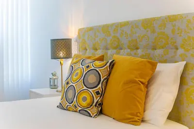 a bedroom with a bed with two pillows and a headboard at Casa de Cristal by Oporto Soul in Porto