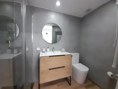 a bathroom with a sink and a toilet and a mirror at Casa de Cristal by Oporto Soul in Porto