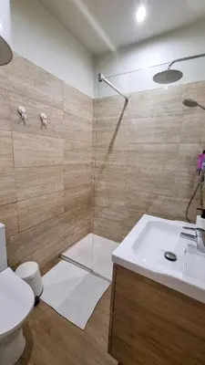 a bathroom with a shower with a sink and a toilet at Oporto Downtown in Porto
